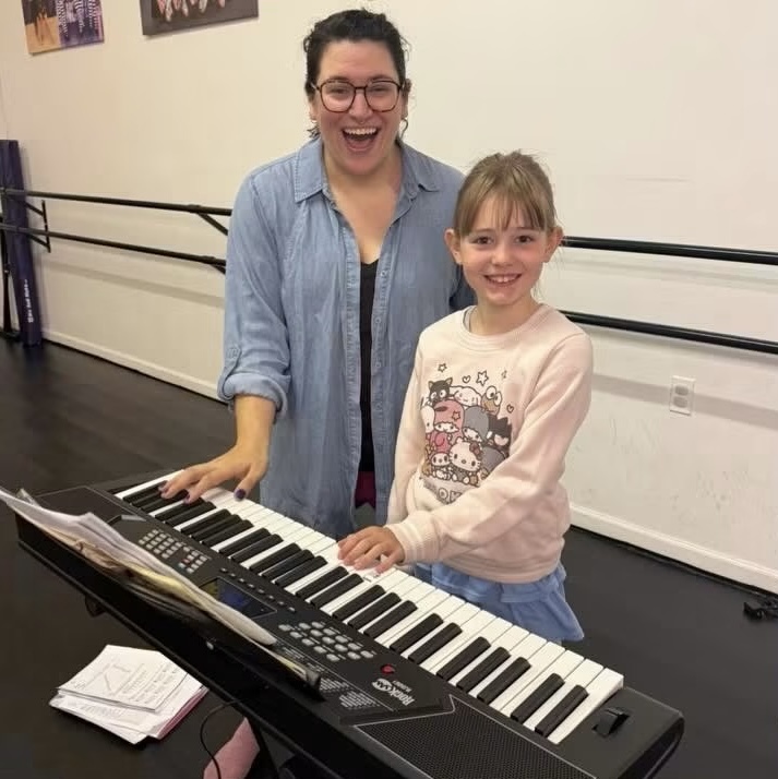 Carleena Manzi teaching a student at the keyboard in her studio